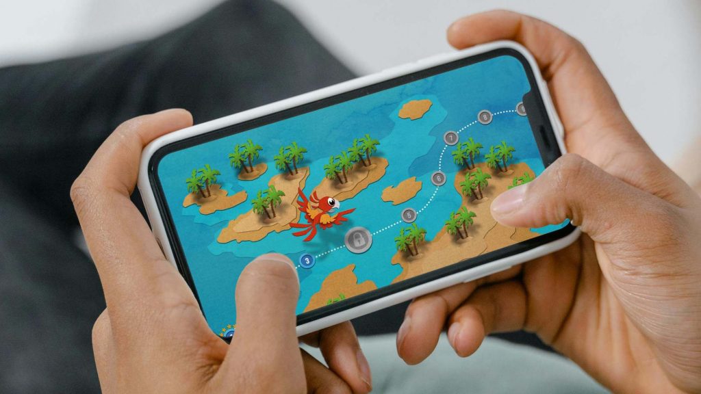 A smartphone showing a game view of a map with islands and a red parrot flying above.